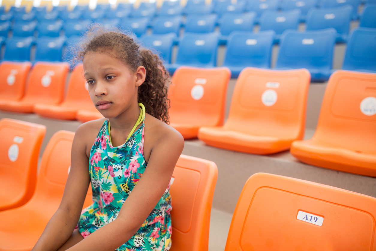 Sad African American teenage girl on a stadium.